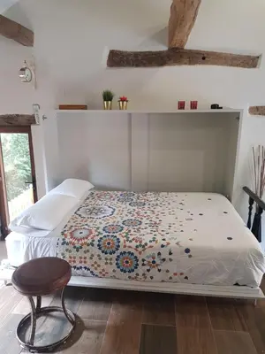 a bedroom with a bed and a chair at EL VIEJO MOLINO in Lugo