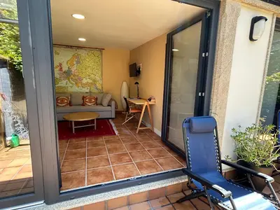 a screened in porch with a chair and a couch at COTOLAI in Santiago de Compostela