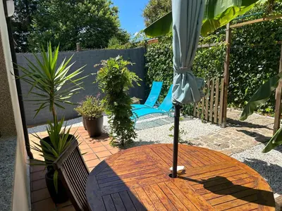 a patio with an umbrella and a table and chairs at COTOLAI in Santiago de Compostela