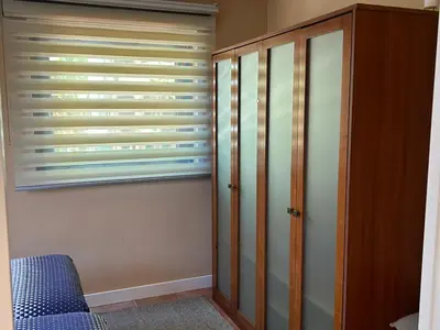a bedroom with a closet and a window at COTOLAI in Santiago de Compostela