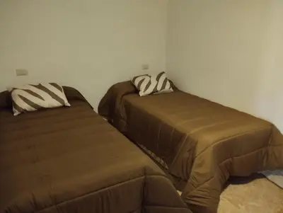 two beds sitting next to each other in a bedroom at Casa Fuentefria in Ourense
