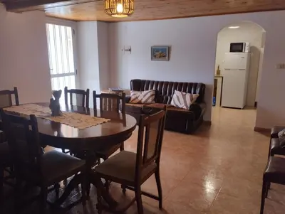 a living room with a table and a couch at Casa Fuentefria in Ourense