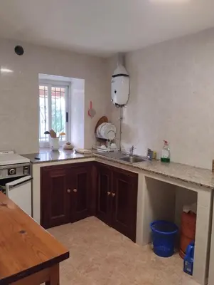 a kitchen with a sink and a counter top at Casa Fuentefria in Ourense