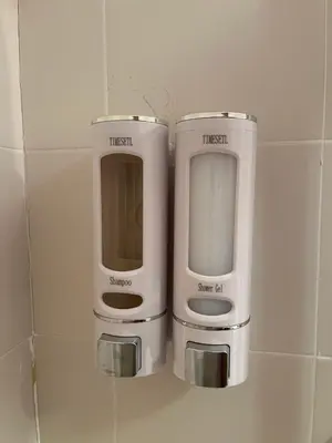 two soap dispensers sitting on a tiled wall at Suite Azucarera in Iria