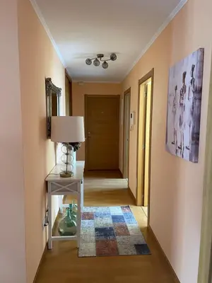 a hallway with a table and a lamp and a door at Suite Azucarera in Iria