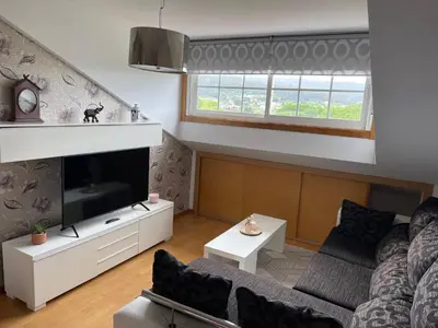 a living room with a couch and a tv at Suite Azucarera in Iria