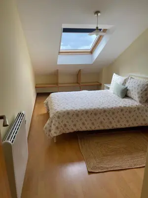 a bedroom with a bed and a skylight at Suite Azucarera in Iria