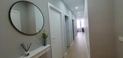 a hallway with a mirror on the wall and a hallway with a hallway at Pisos uso turistico Torno-Cubelas-Caosa Buenavista in San Ciprián