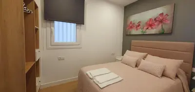 a bedroom with a bed with two towels on it at Pisos uso turistico Torno-Cubelas-Caosa Buenavista in San Ciprián