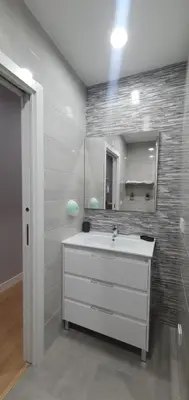a bathroom with a white sink and a mirror at Pisos uso turistico Torno-Cubelas-Caosa Buenavista in San Ciprián