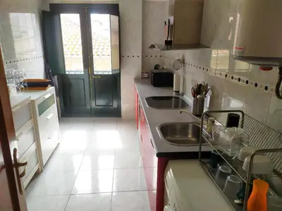 a small kitchen with a sink and a window at Piso BOLBORETEIRO in Allariz