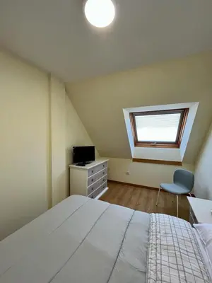 a bedroom with a large white bed and a window at Centro de Miño - Pumariega in Miño