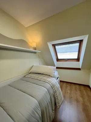 a bedroom with a bed and a window at Centro de Miño - Pumariega in Miño