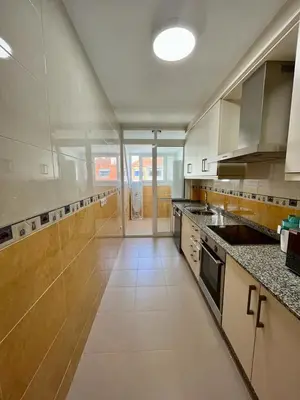 a large kitchen with white cabinets and a large window at Centro de Miño - Pumariega in Miño