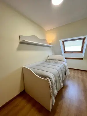 a bedroom with a bed in a room with a window at Centro de Miño - Pumariega in Miño