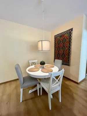 a white dining room table with chairs and a potted plant at Centro de Miño - Pumariega in Miño
