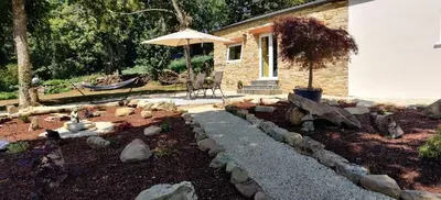 a garden with a stone pathway and an umbrella at La Casita in Lugo