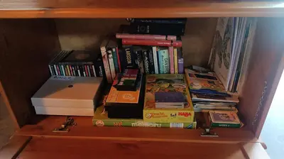 a book shelf with a stack of books and a printer at La Casita in Lugo