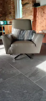 a brown leather couch with two pillows on it at La Casita in Lugo