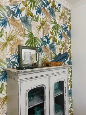 a room with a white cabinet with a tropical wallpaper at Bodega Sibeiro in Chantada