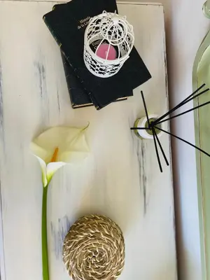 a table with a book and a flower and a nest at Bodega Sibeiro in Chantada