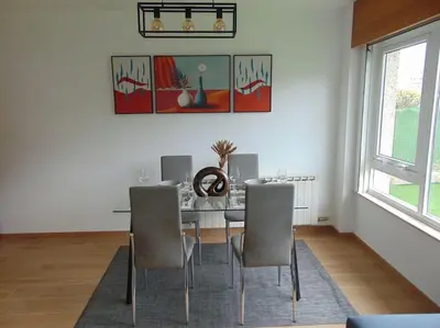 a dining room with a table and chairs at apartamento con jardin in Santiago de Compostela