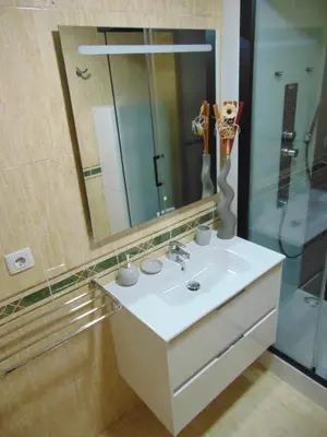 a bathroom with a sink and a mirror at apartamento con jardin in Santiago de Compostela