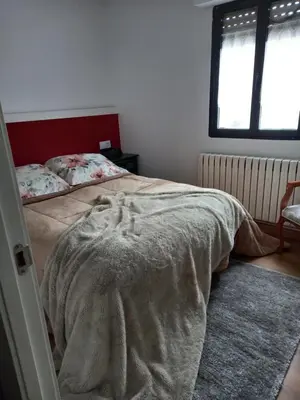 a bedroom with a bed with a blanket on it at Casa CACHAMARIA próxima a la ribeira sacra in Ourense
