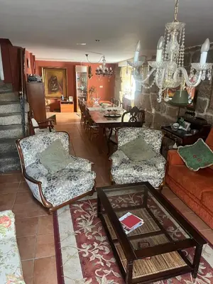 a living room with a couch and a table at Casa CACHAMARIA próxima a la ribeira sacra in Ourense