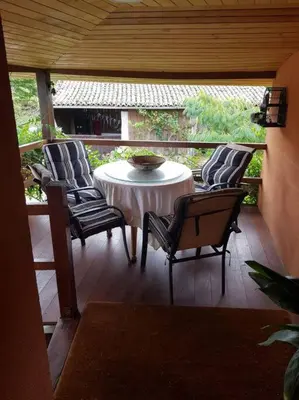 a patio with a table and chairs on a porch at Casa CACHAMARIA próxima a la ribeira sacra in Ourense