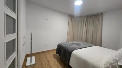 a small bedroom with a bed and a window at C&C Suite in San Ciprián