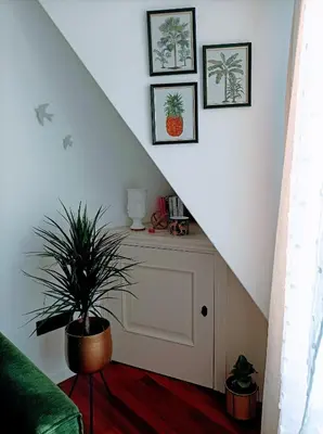 a stair case with a plant in a room at O balcón do Río in Caldas de Reis