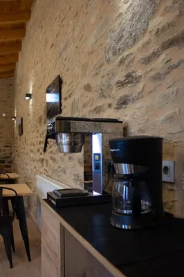 a kitchen with a coffee maker on a counter at Casa Rural Camino Real Completa in Melide