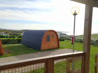 a hobbit house on a deck with a fire hydrant at Bungalow 3 personas - Camping Playa de Tapia in Tapia de Casariego