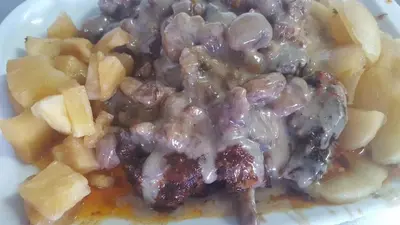 a white plate of food with meat and potatoes at Casa Rural Turística Casa Nicolau 1 in Barbudo