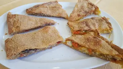 a white plate with four pieces of sandwiches on it at Casa Rural Turística Casa Nicolau 1 in Barbudo