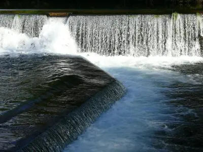 a waterfall with water coming out of it at Casa Rural Turística Casa Nicolau 1 in Barbudo