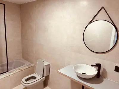 a bathroom with a toilet and a sink and a mirror at Villa Clásica en Santiago 