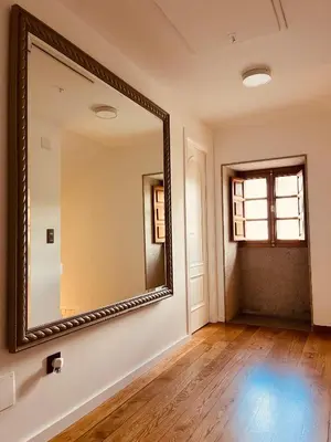 an empty room with a large mirror on the wall at Villa Clásica en Santiago 
